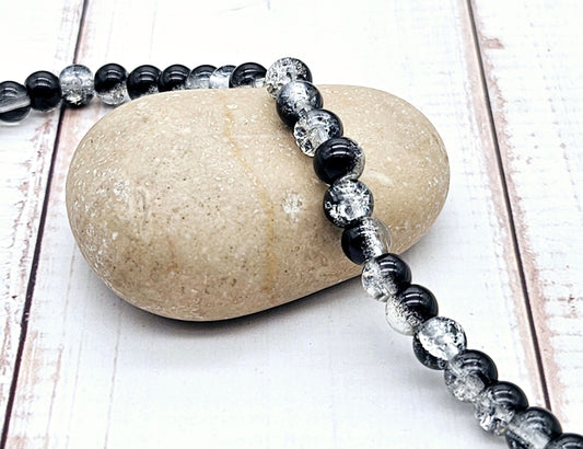 130 perles en verre craquelées noires et transparentes 6mm